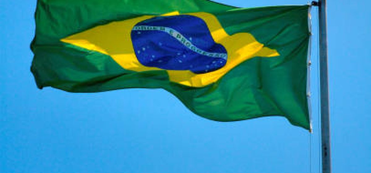 Brazilian flag viewed from below with clear blue sky